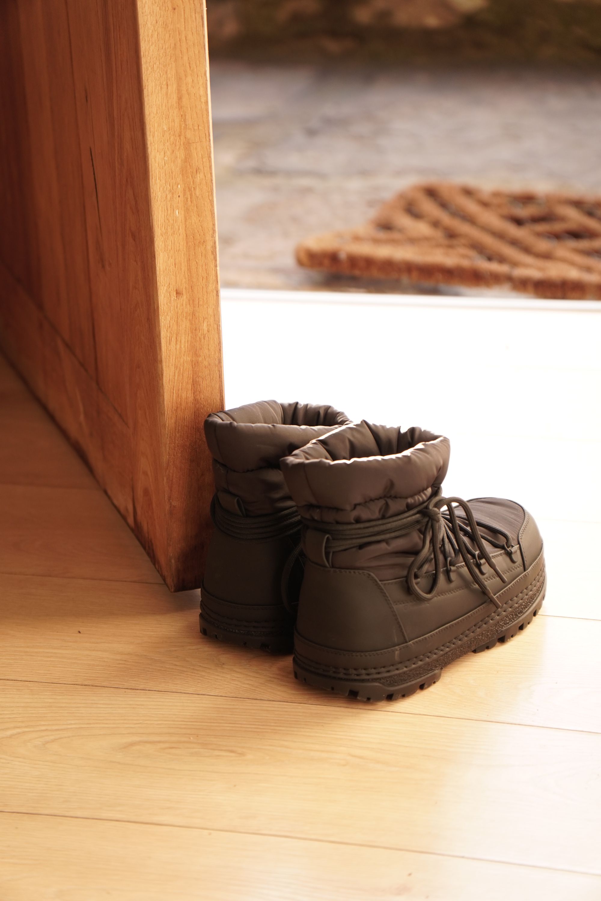 Illustrative boots by a doorway; no SOTHING product shown