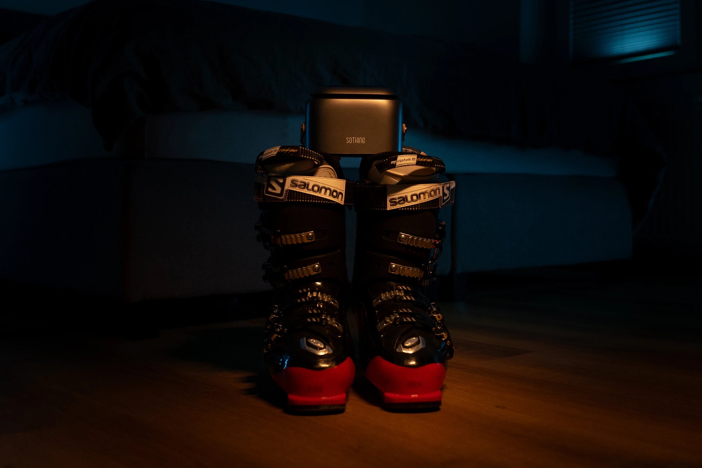 Ultra Grey positioned above ski boots in an evening room scene
